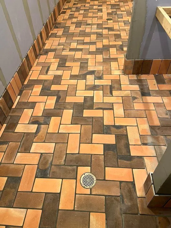 Completed terracotta herringbone tile floor