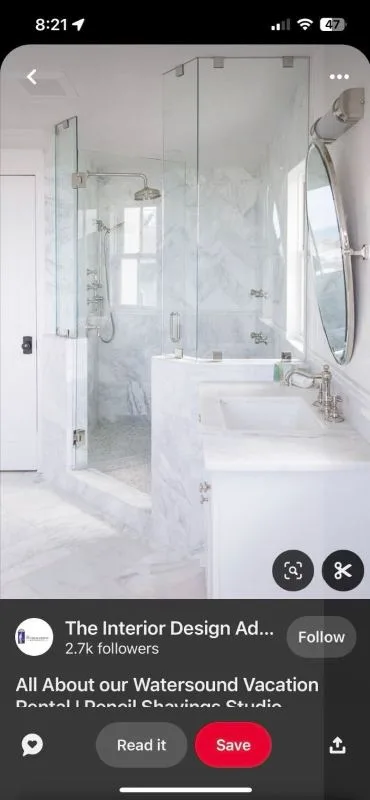 Completed bath and shower with marble tiled surround