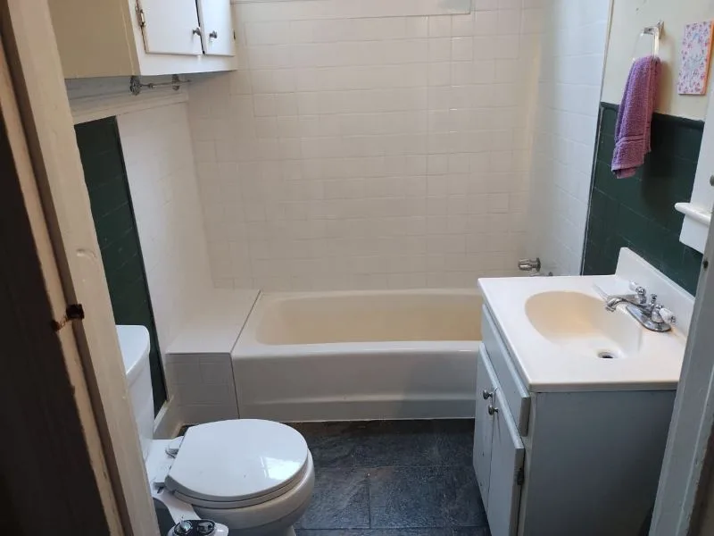 Completed bathroom with bath, vanity and tiled floor
