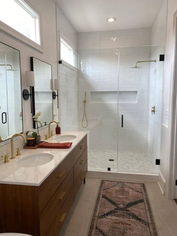 Completed walk-in glass shower with brass fixtures
