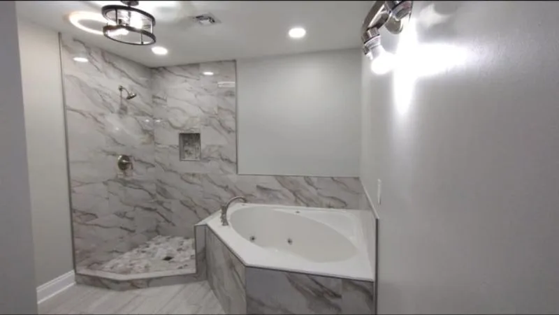Completed corner bath with a marble tiled surround