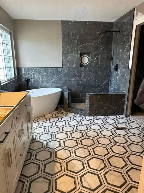 Bathroom with hexagon tile flooring and a freestanding tub
