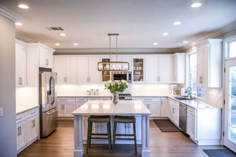 Kitchen with an island, white cabinetry and stainless appliances