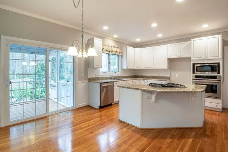 Kitchen with an island and timber flooring